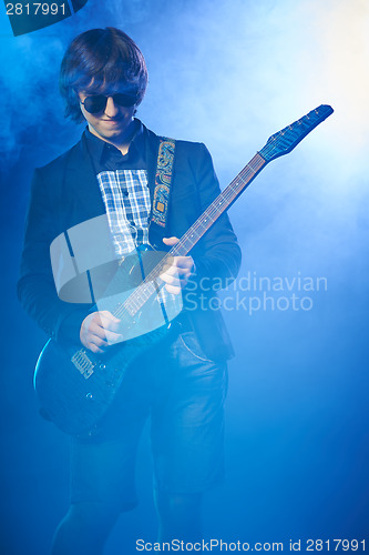 Image of Young guitarist performing on stage