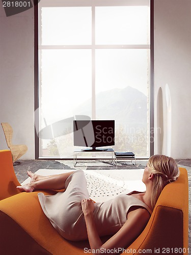 Image of Blond woman watching TV