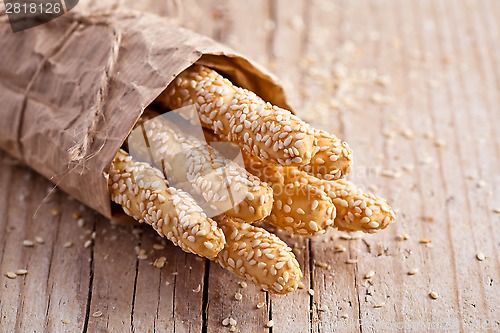 Image of bread sticks grissini with sesame seeds in craft pack 