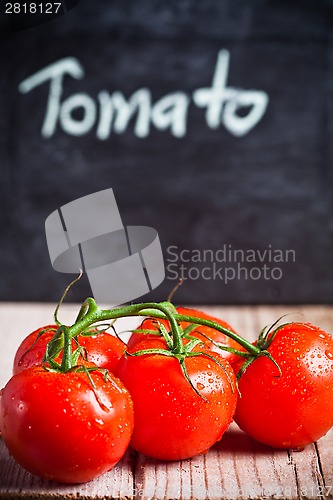 Image of fresh tomatoes and blackboard 