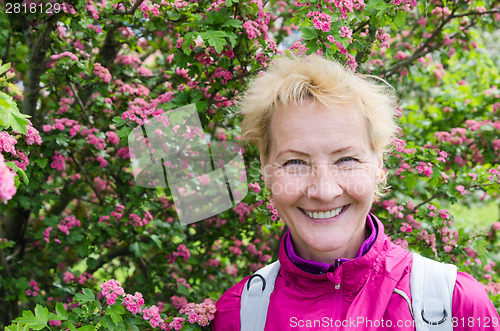 Image of Portrait of a woman in a blossoming hawthorn