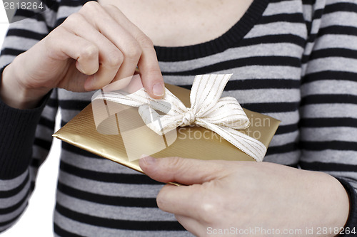 Image of Young woman holding a present