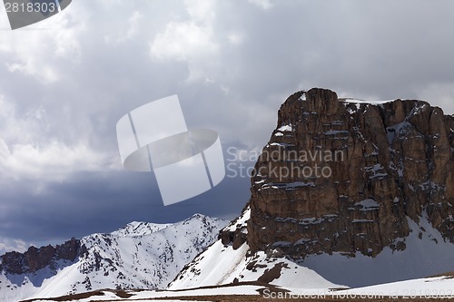 Image of Snowy rocks and cloudy sky