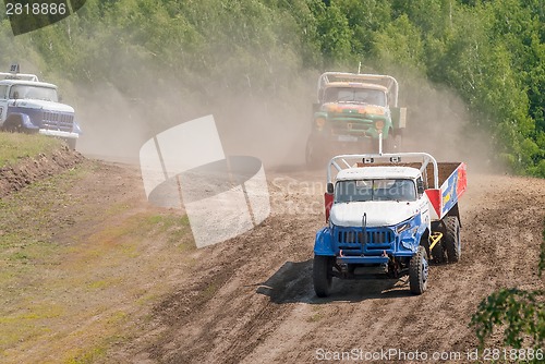 Image of Trucks racing on unpaved sport track