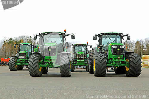 Image of Four John Deere Agricultural Tractors on a Yard