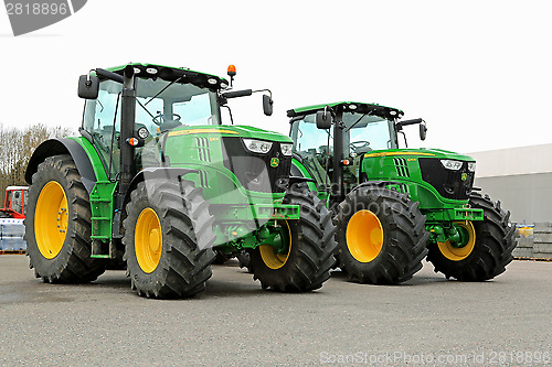 Image of Two John Deere 6210R Agricultural Tractors on a Yard.