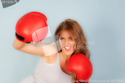 Image of Beautiful woman wearing boxing gloves