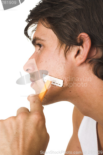 Image of close up of young man shaving