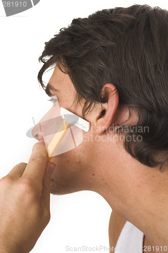 Image of close up of young man shaving