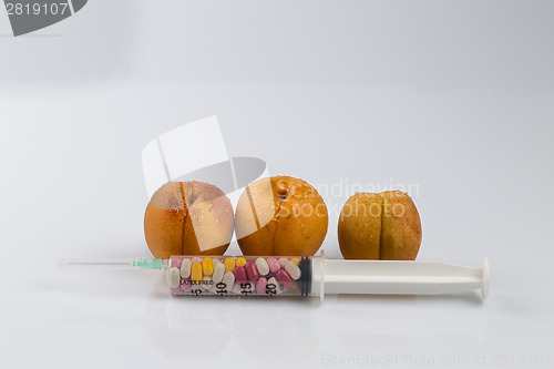 Image of Peaches and syringe with pills