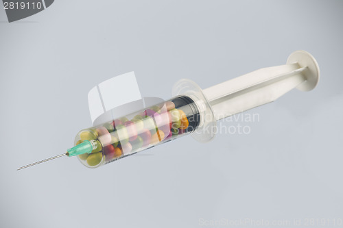 Image of syringe and pills