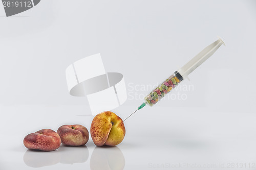 Image of Peaches and syringe with pills