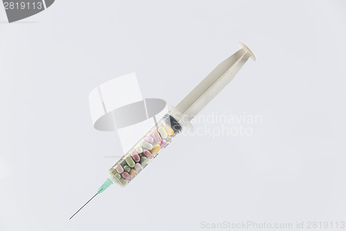 Image of syringe and pills