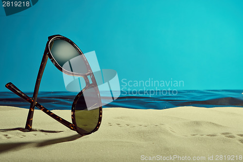 Image of sunglasses on the beach