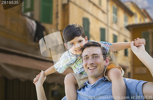 Image of Father and Son Playing Piggyback on Streets of France