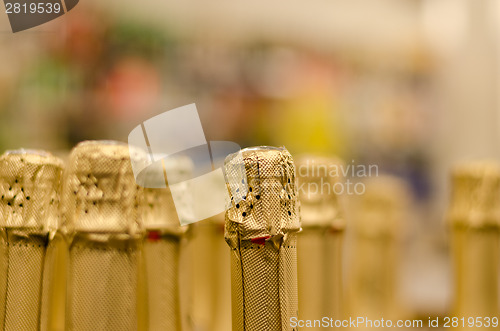 Image of close up champagne bottle cork wrapped shiny paper 