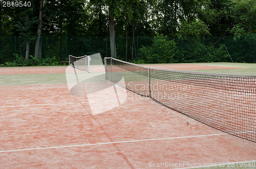 Image of tennis courts in recreation village park summer  