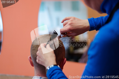 Image of man haircut at the barber scissors  