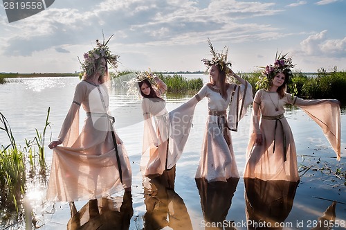 Image of Pretty women with flower wreath in water