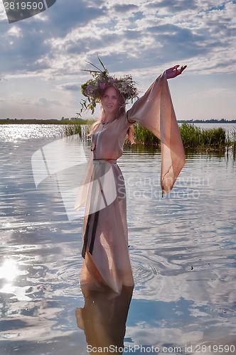 Image of Beautiful woman with flower wreath in watet