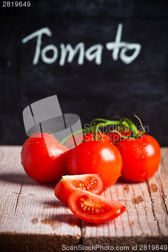 Image of fresh tomatoes and blackboard 