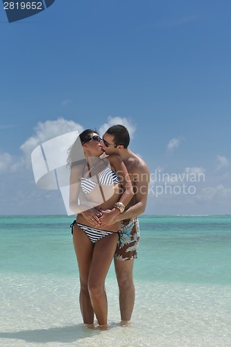 Image of happy young couple have fun on beach