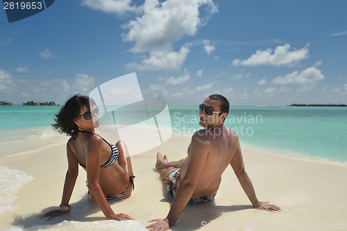 Image of happy young couple have fun on beach