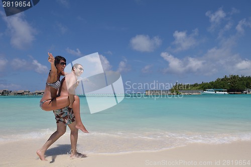 Image of happy young couple have fun on beach