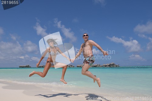 Image of happy young couple have fun on beach