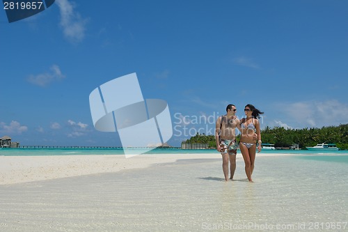 Image of happy young couple have fun on beach