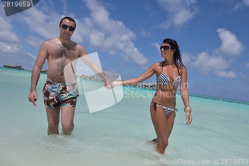 Image of happy young couple have fun on beach