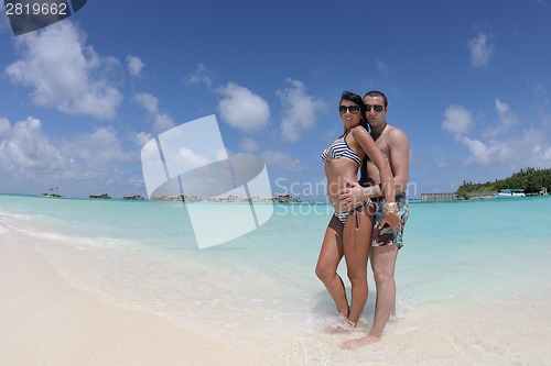 Image of happy young couple have fun on beach