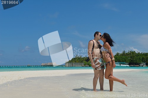 Image of happy young couple have fun on beach