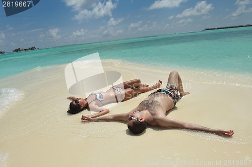 Image of happy young couple have fun on beach