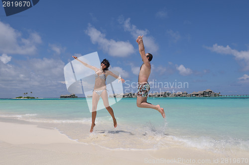 Image of happy young couple have fun on beach