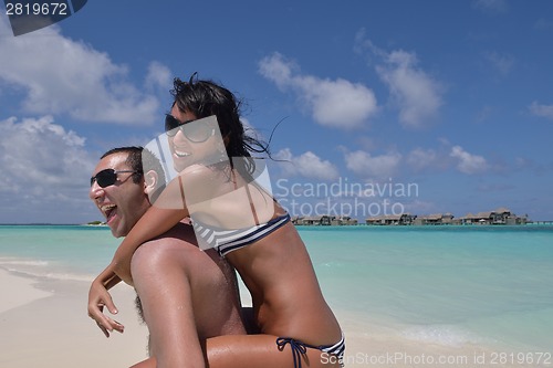 Image of happy young couple have fun on beach