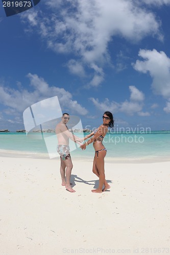 Image of happy young couple have fun on beach