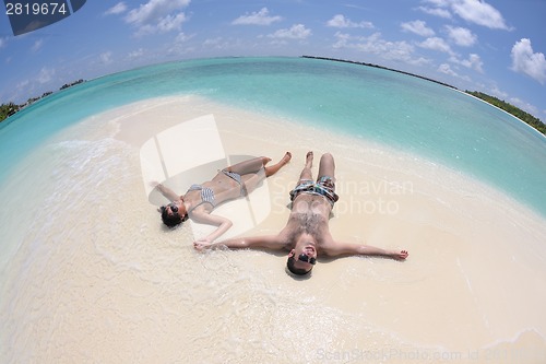 Image of happy young couple have fun on beach