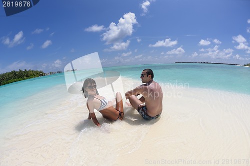 Image of happy young couple have fun on beach