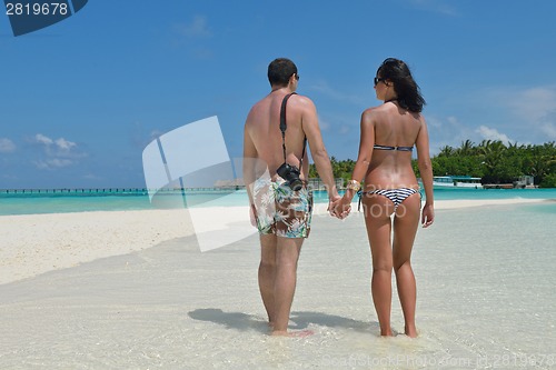 Image of happy young couple have fun on beach