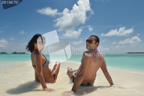 Image of happy young couple have fun on beach