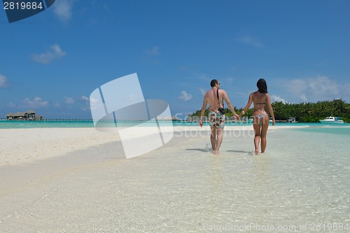 Image of happy young couple have fun on beach