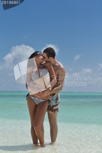 Image of happy young couple have fun on beach