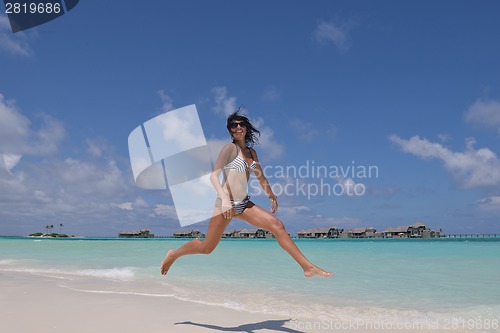 Image of beautiful young woman  on beach have fun and relax