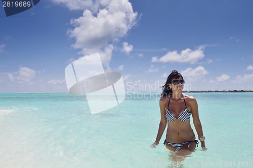 Image of beautiful young woman  on beach have fun and relax