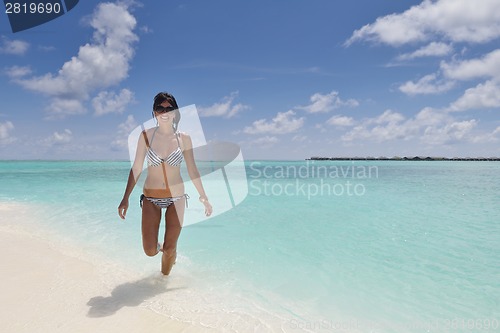 Image of beautiful young woman  on beach have fun and relax