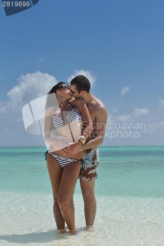 Image of happy young couple have fun on beach