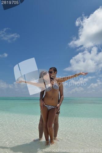 Image of happy young couple have fun on beach