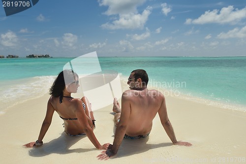 Image of happy young couple have fun on beach