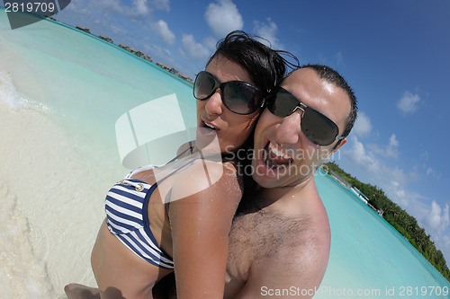 Image of happy young couple have fun on beach